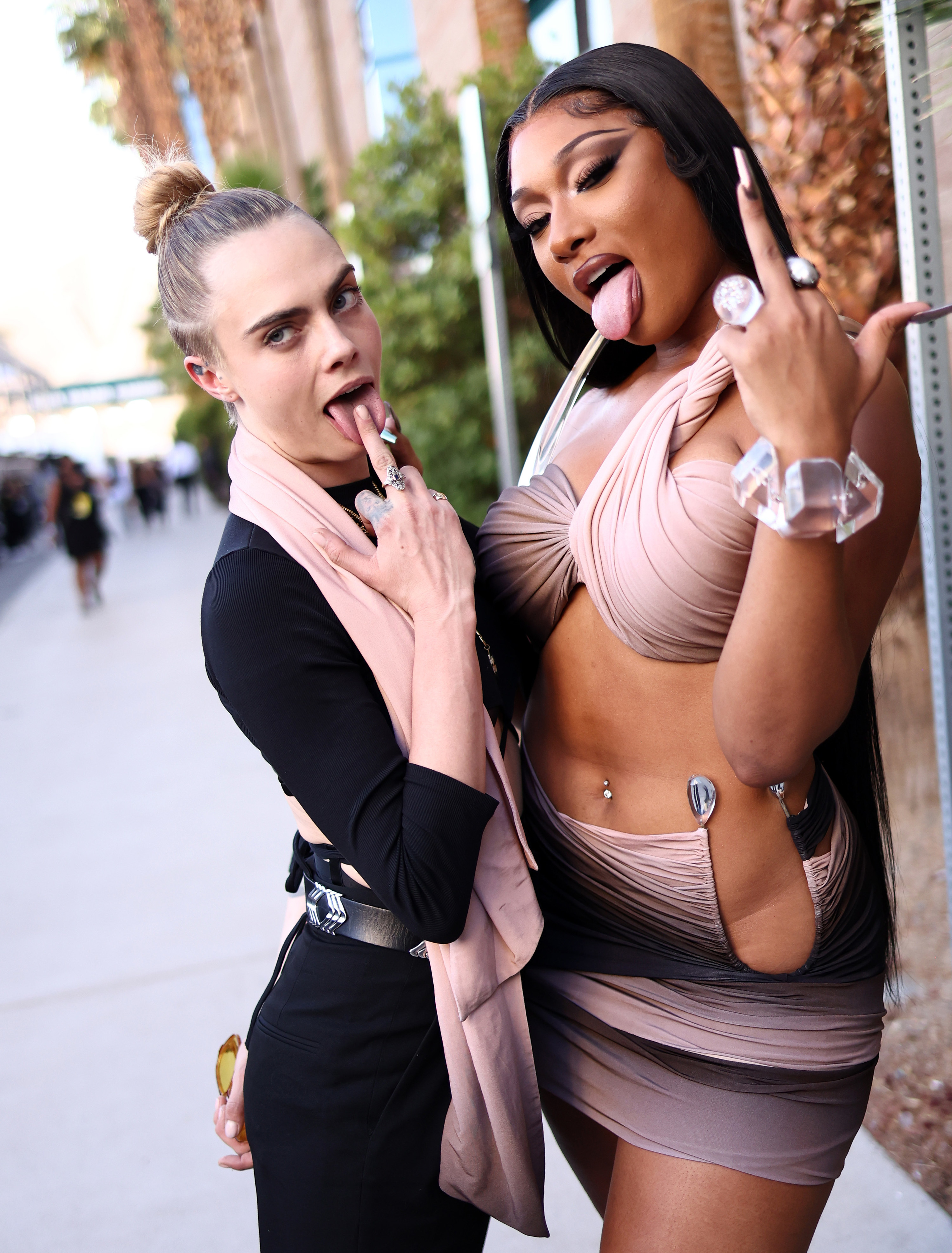 Cara and Megan both flipping off the camera with their tongues out