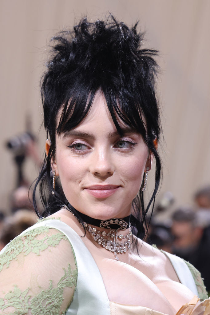 Close-up of Billie smiling and wearing a choker and gemstone necklace