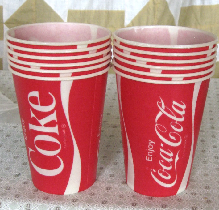 Stacks of Coke branded paper cups