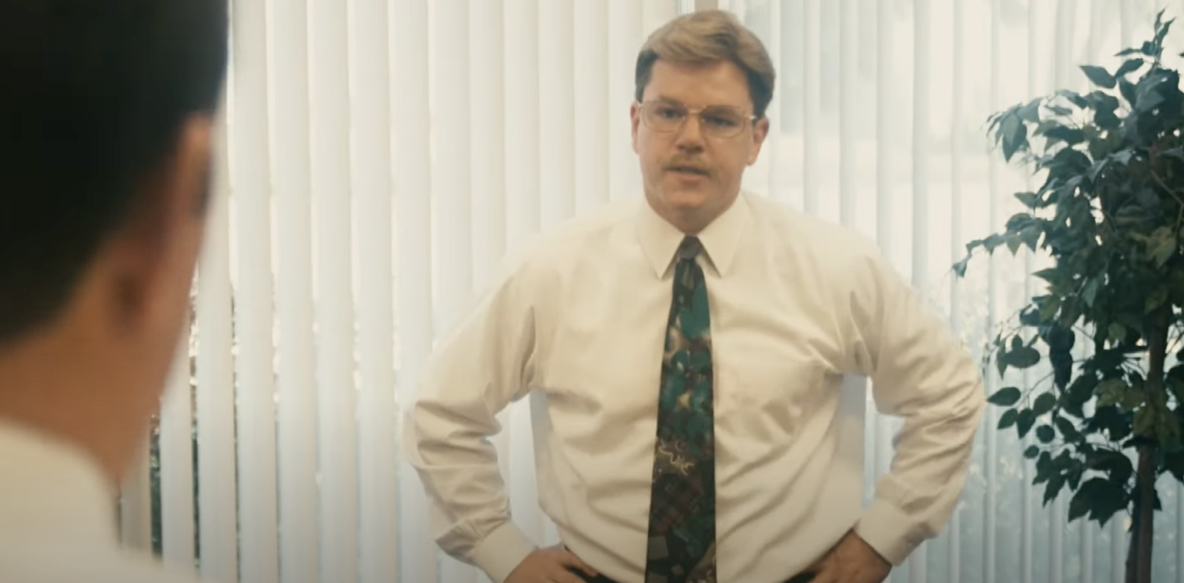 Matt Damon with a tie, glasses, and mustache