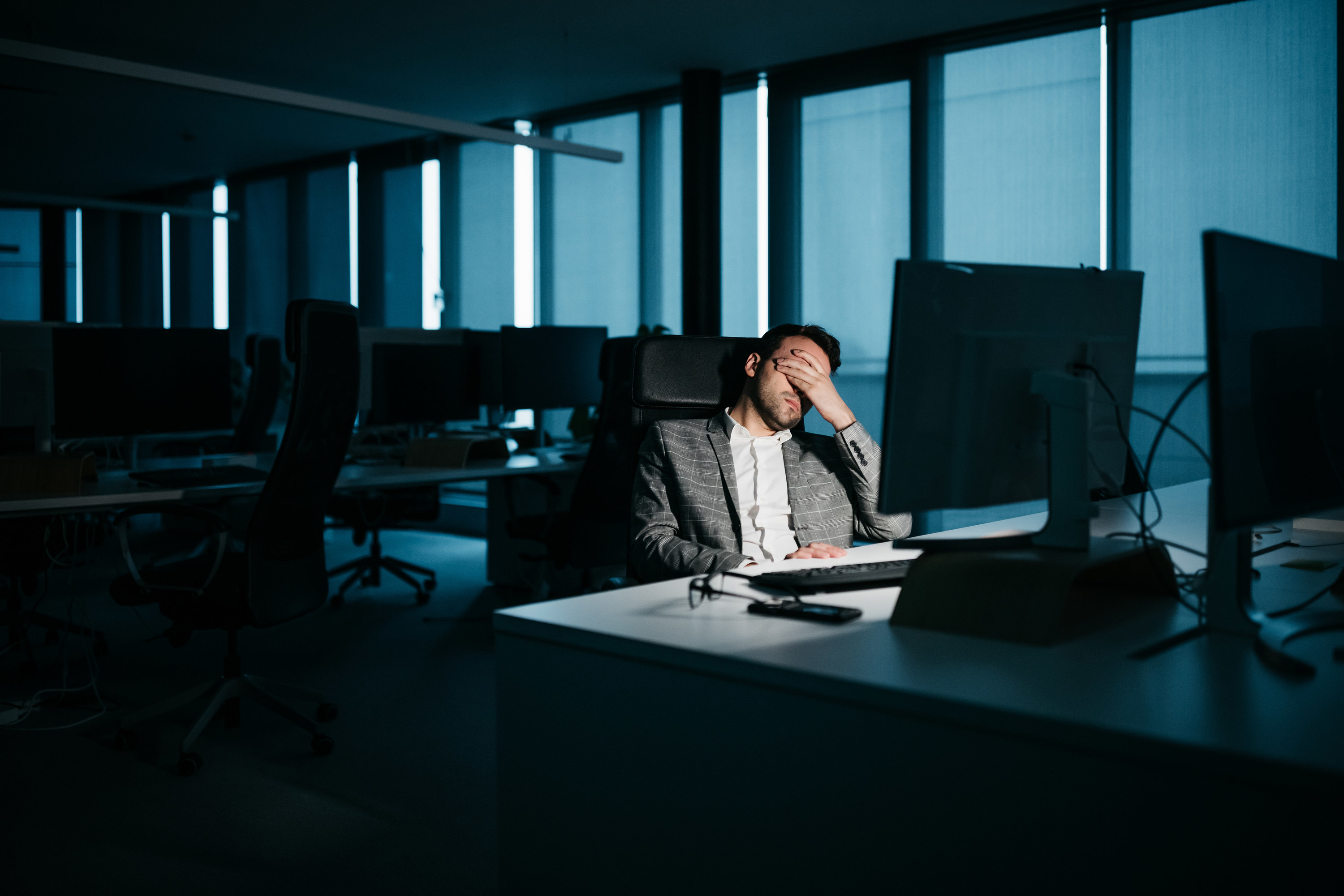 burned out man working late at night