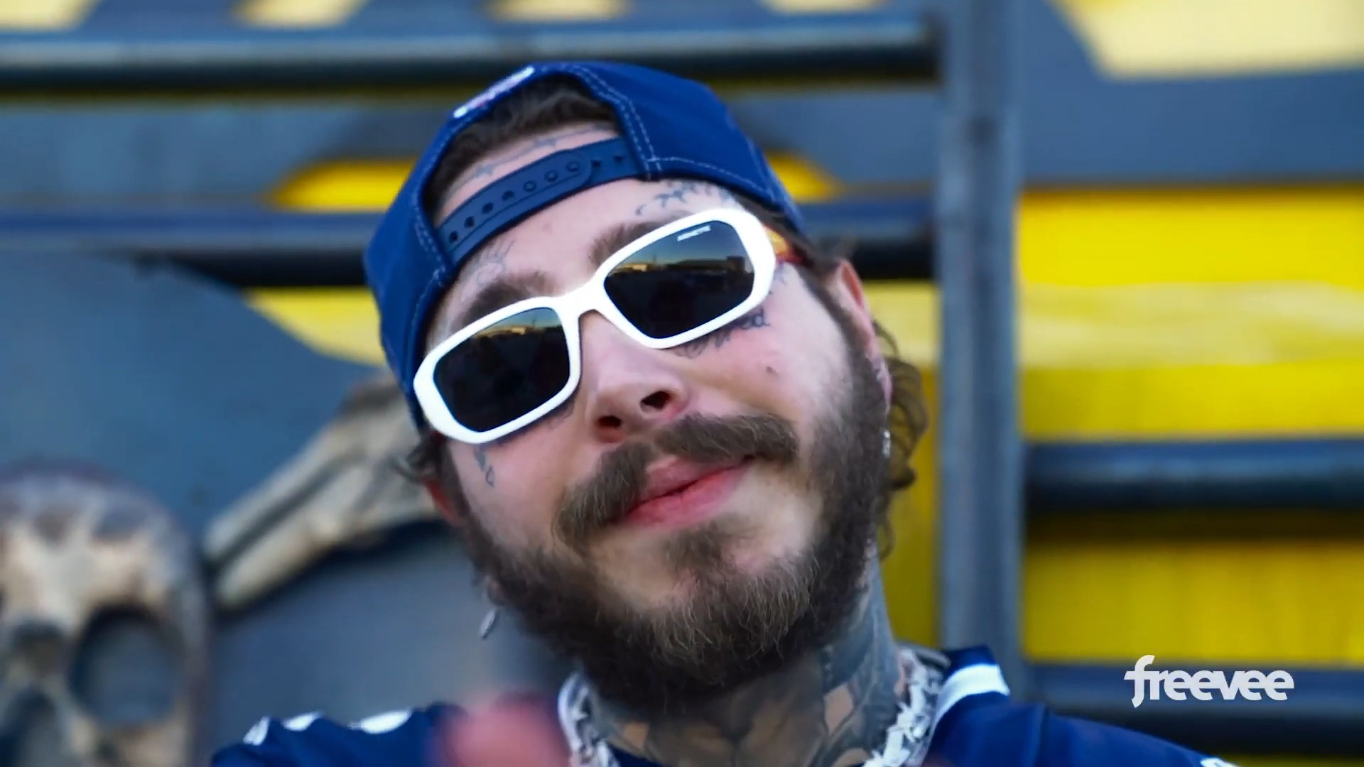 Post Malone smiling at the camera in &quot;Post Malone: Runaway&quot;