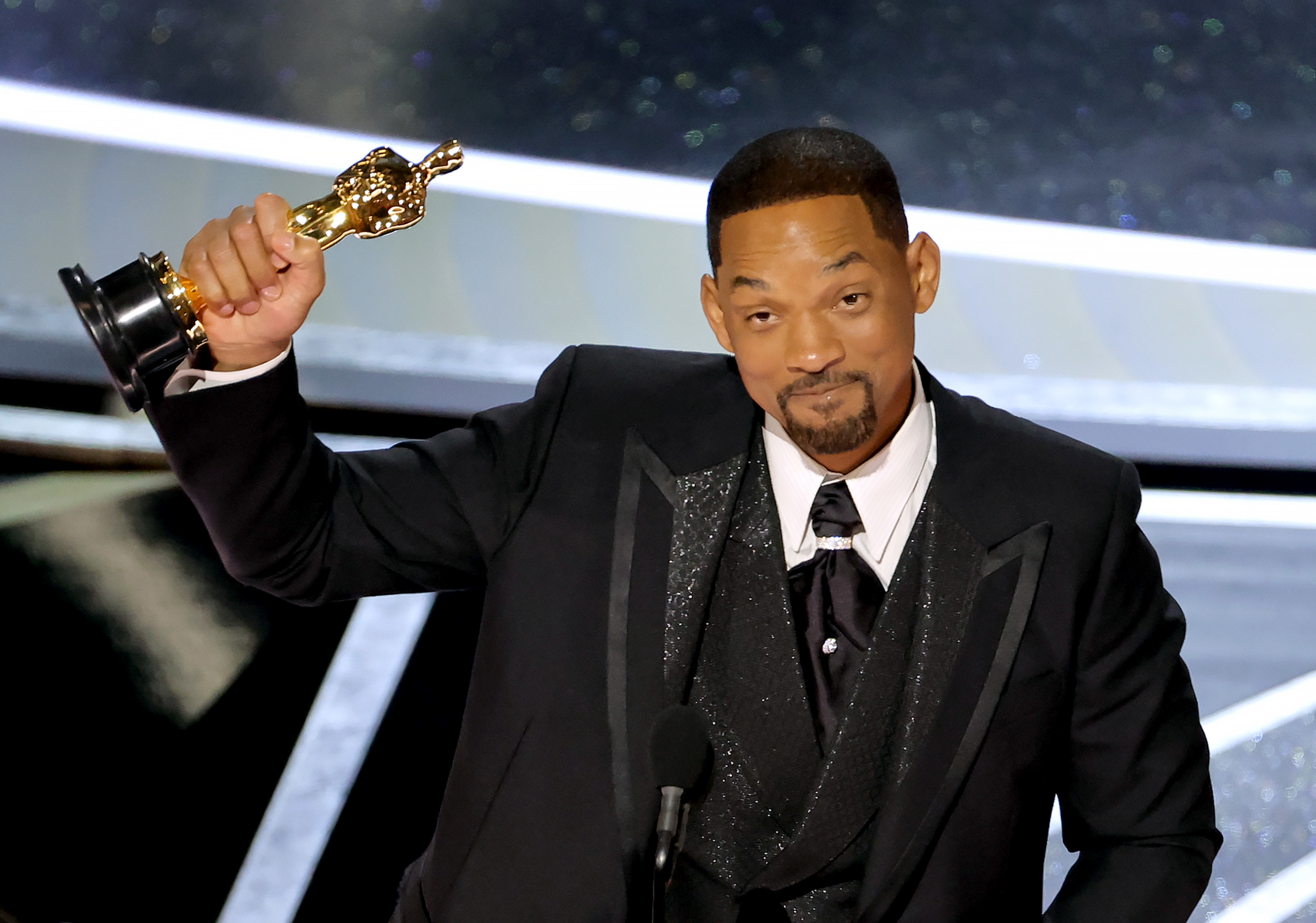 Will holding up his Oscar onstage at the podium