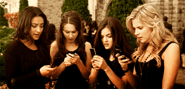 A group of girls reading their phones