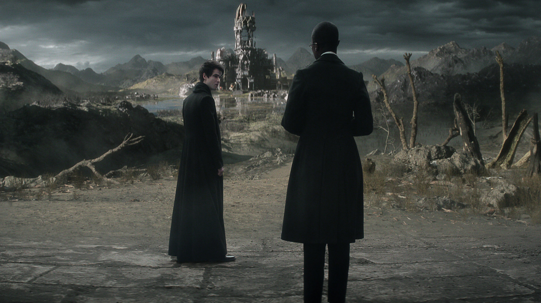 The sandman a tall cloaked man stands in front of a ruined castle in the distance and looks back at lucienne the library in a black suit