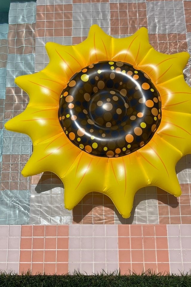 a sunflower-shaped pool float in a pool
