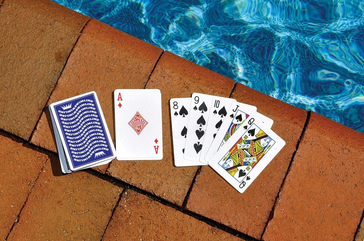playing cards laid out next to a pool