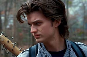 A close up of Steve Harrington as he carries a bat with nails in it