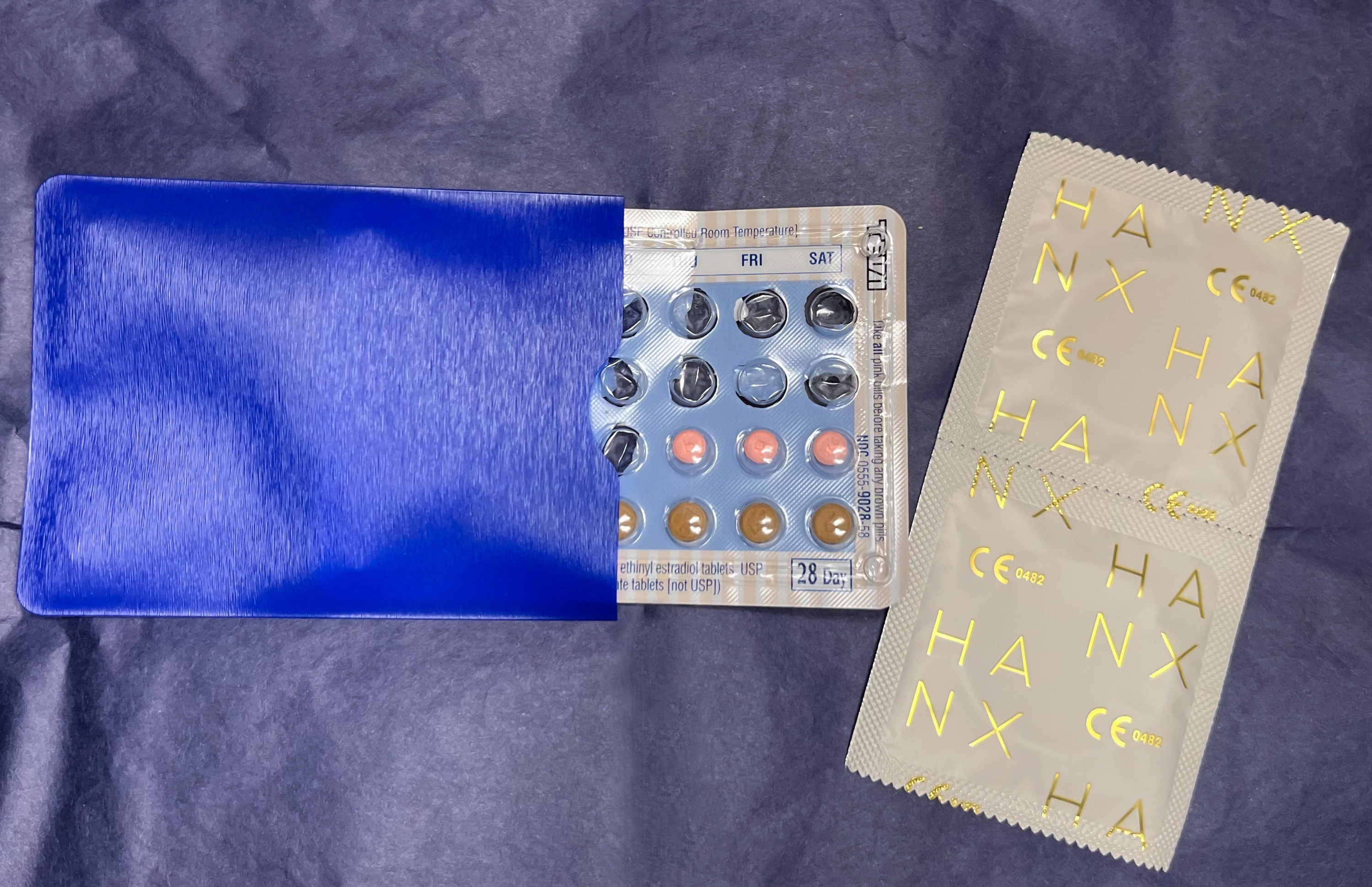 An image of birth control pack of pills and condoms