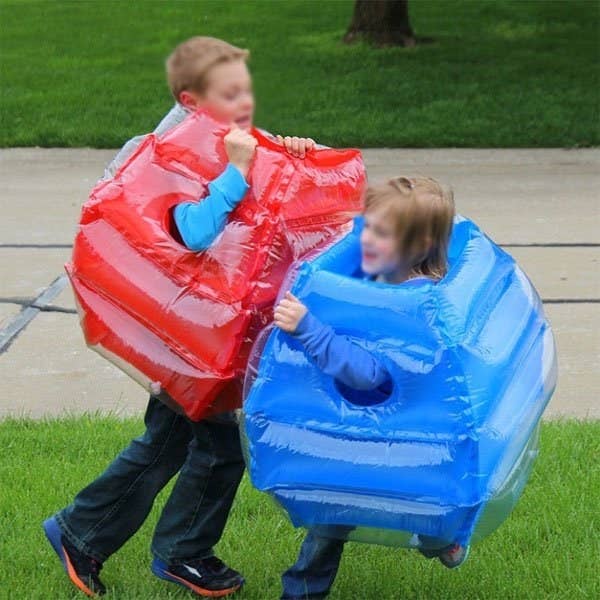 Two children playing with inflatable body bumpers