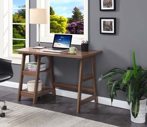 a cappuccino trestle desk with a laptop and coffee cup in a home office