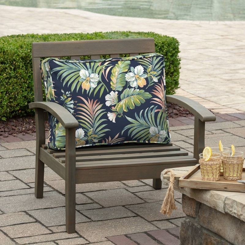 a tropical blue plush deep seat pillow on an outdoor chair