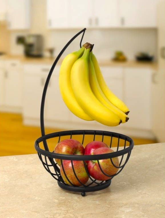 Bananas and apples in bowl and holder