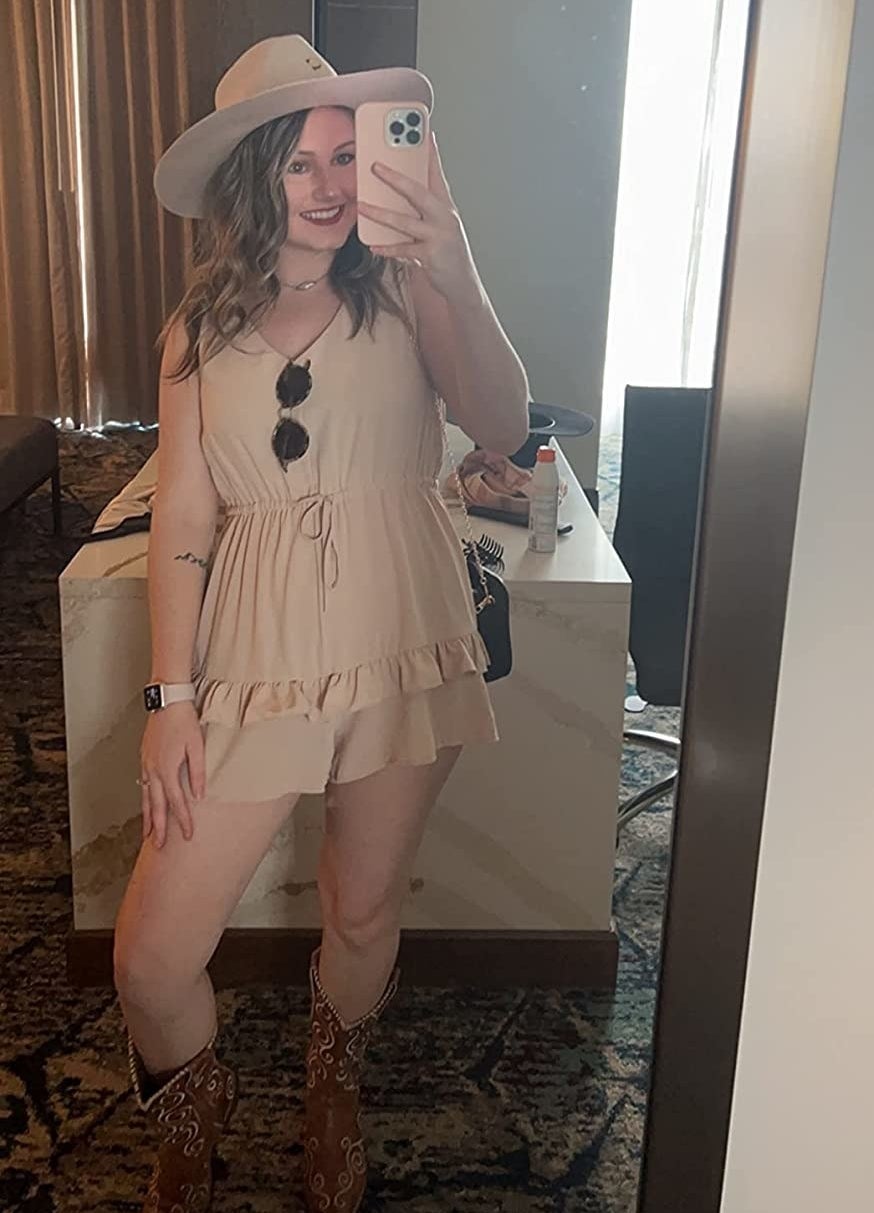 reviewer wearing the light brown ruffled romper