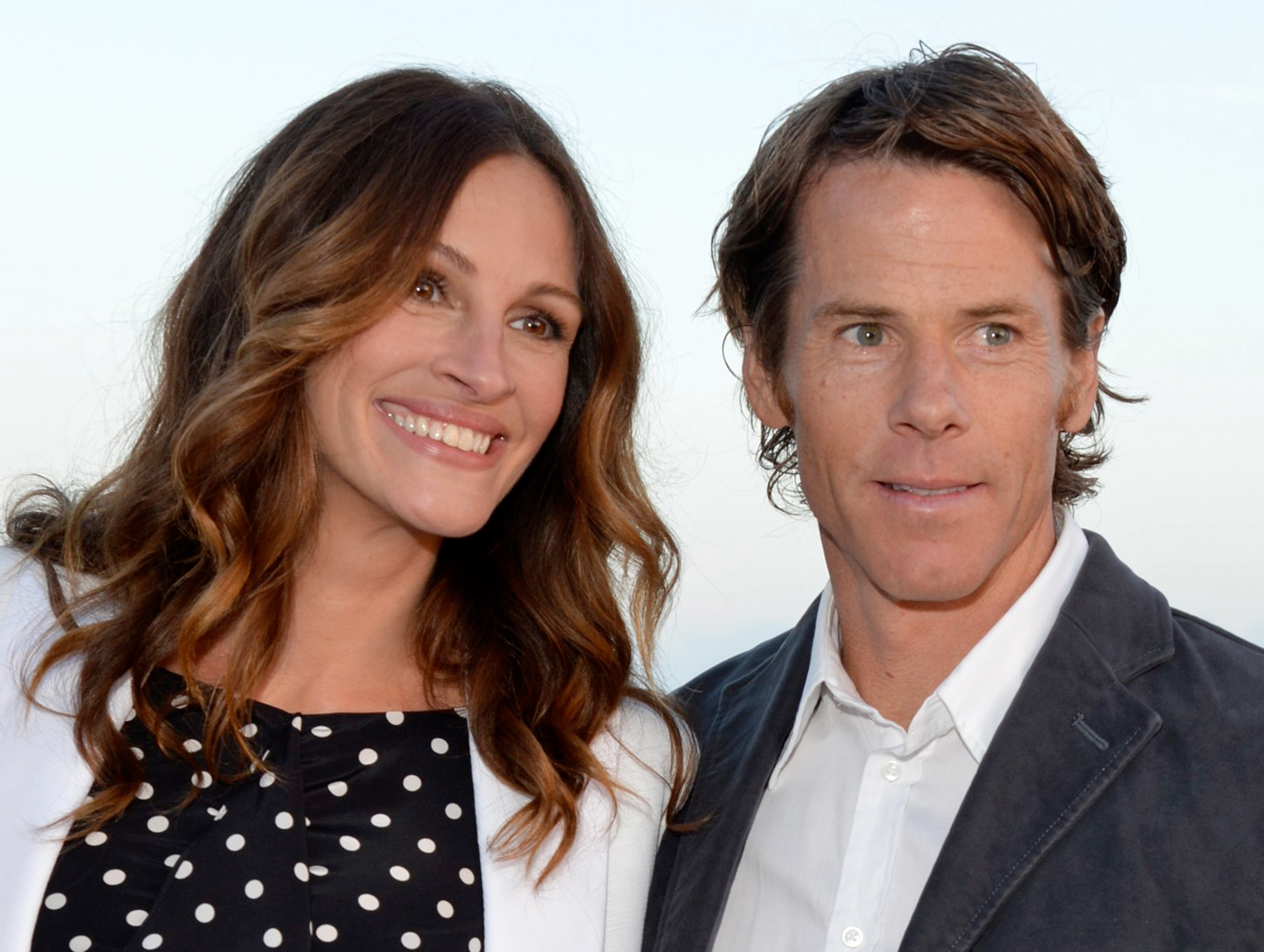 Julia Roberts in a polkadot dress and Daniel Moder in 2012 posing for the camera