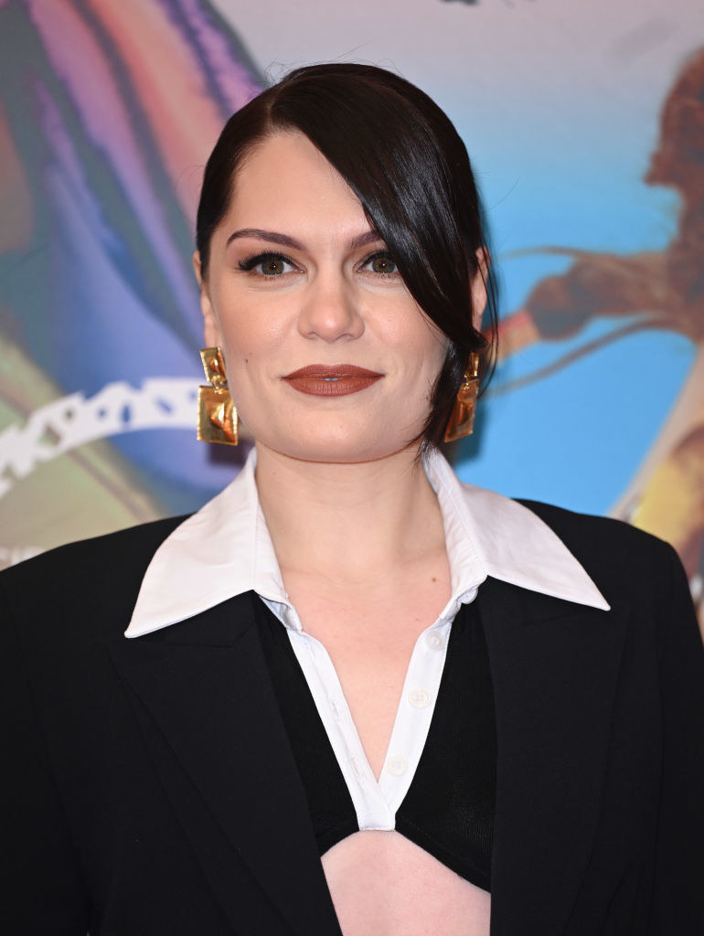 Jessie J in gold earrings posing for a photograph