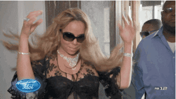 Mariah Carey flashing her hair with sunglasses on