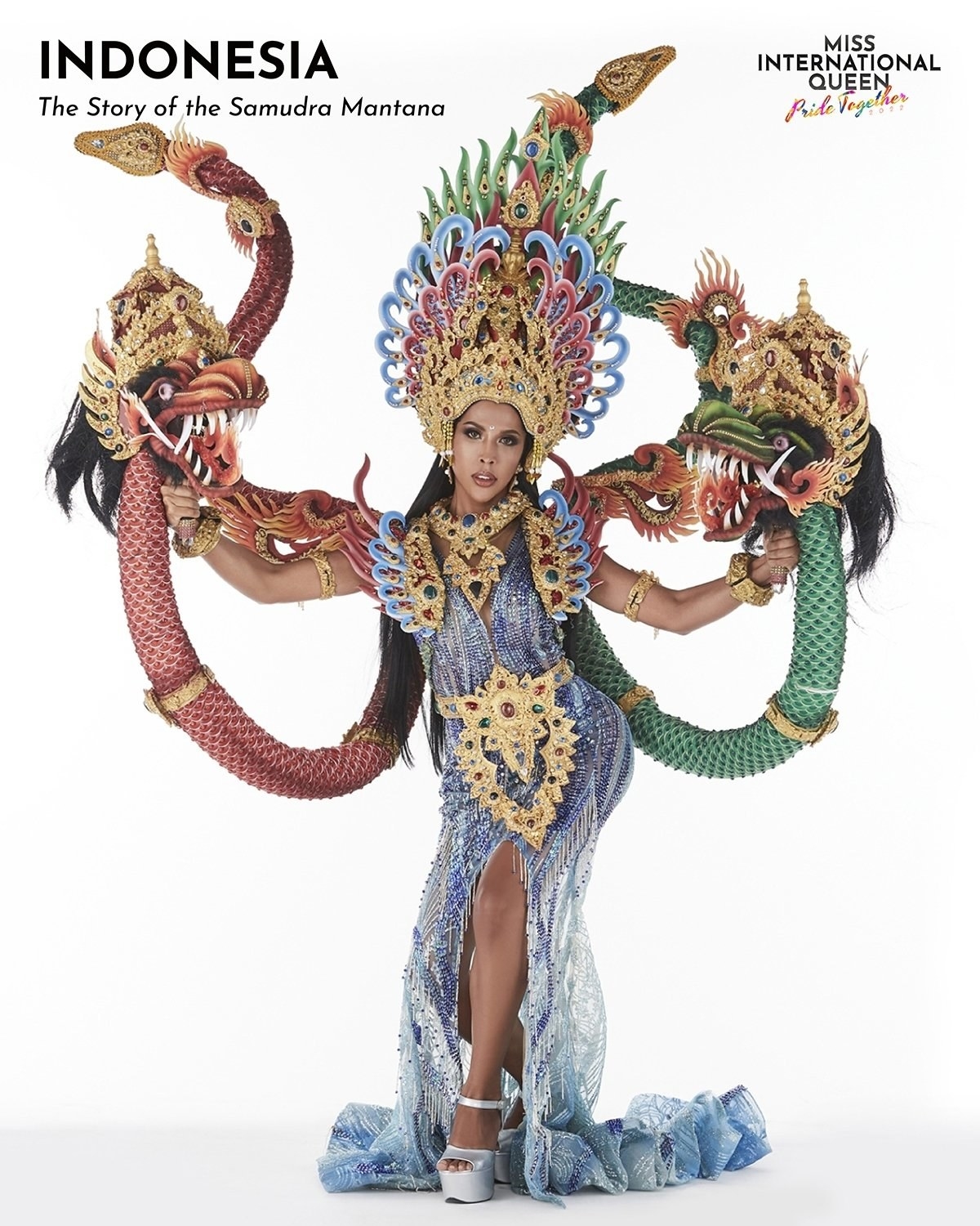 Miss Indonesia in a blue dress and holding decorative snakes
