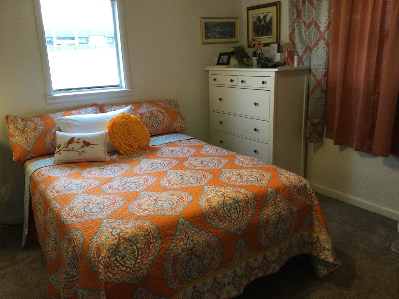 Reviewer&#x27;s photo showing the damask side of quilt out on bed