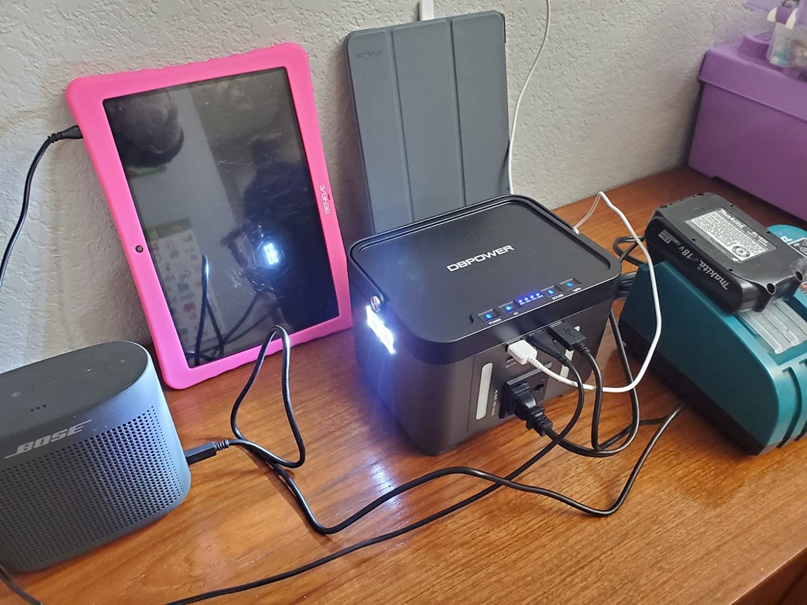 reviewer&#x27;s photo of multiple devices plugged into the power bank