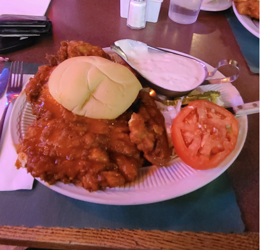 buffalo chicken that is way bigger than the bread a huge dish of ranch on the side