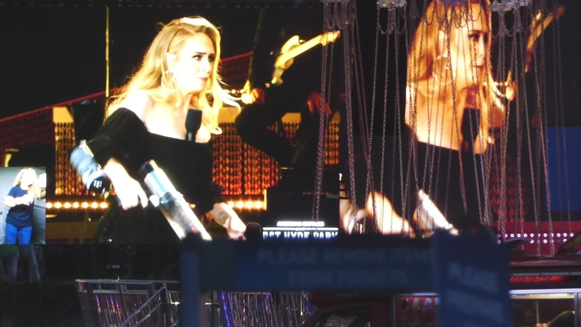Adele holding a T-shirt gun during a concert