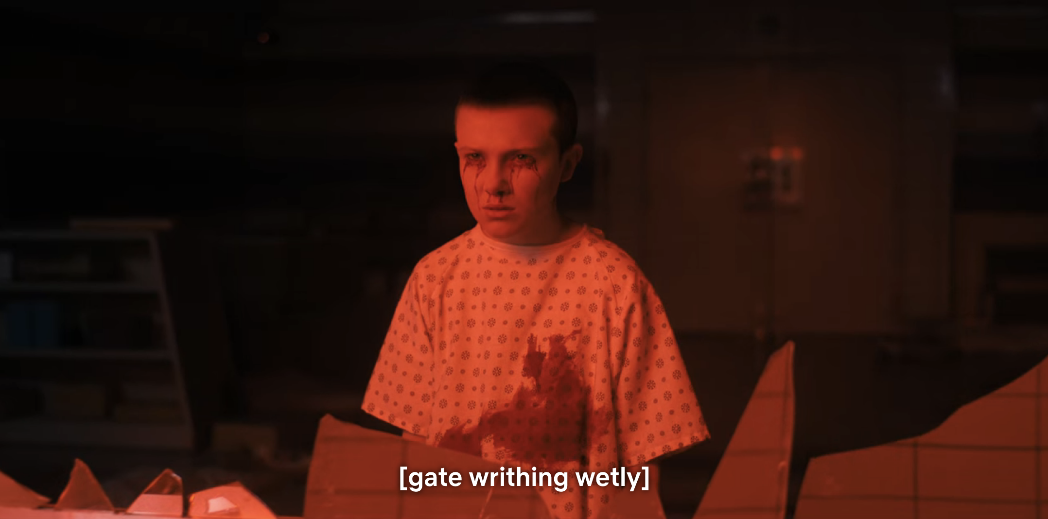 eleven standing in a hospital gown