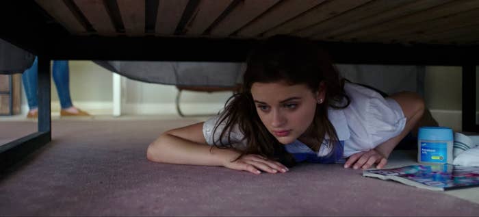 Joey hiding under a bed in one of the Kissing Booth movies