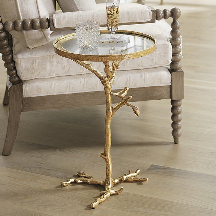 a gold bird and branch-detailed end table