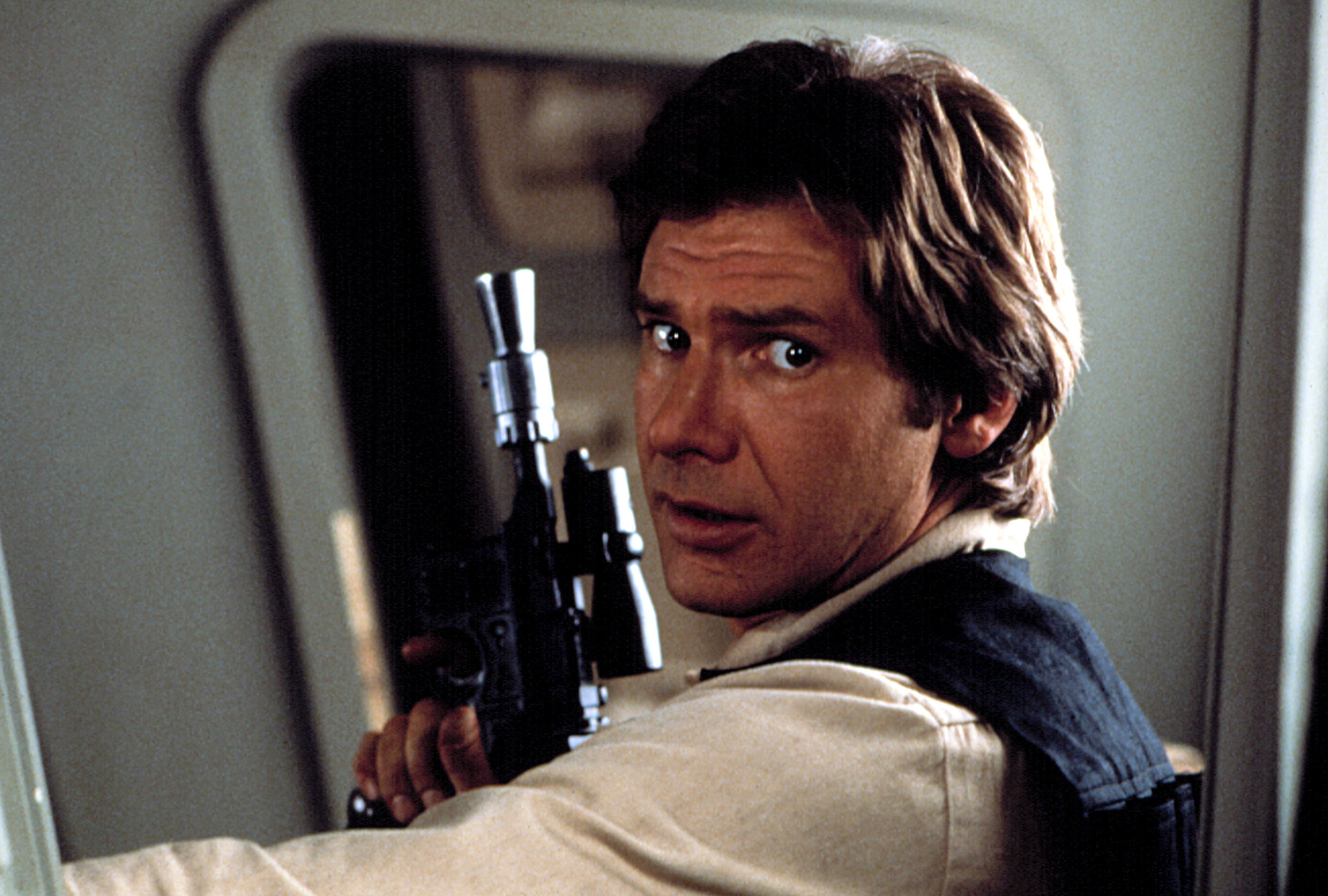 A young Harrison as Han holding a weapon