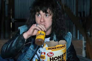 Eddie from Stranger Things drinking a Yoohoo and holding a box of Honey Comb cereal