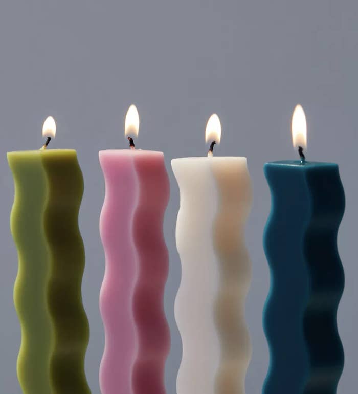 a set of four wavy taper candles