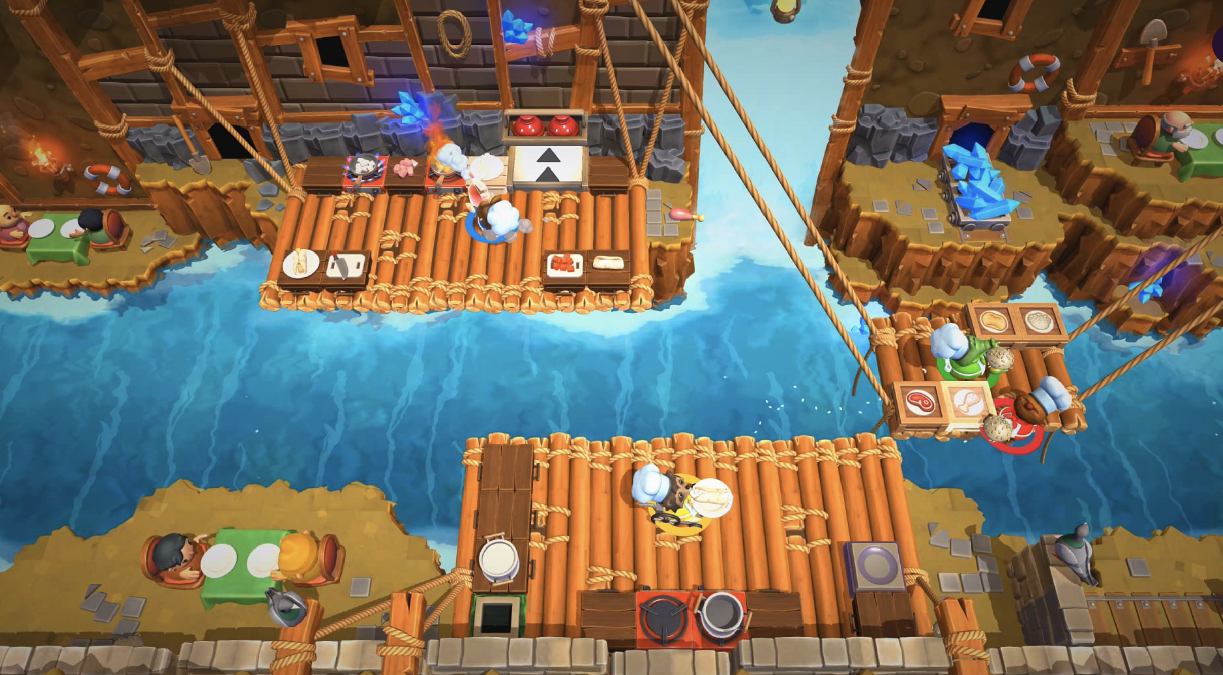 A screenshot of the &quot;Overcooked&quot; game of a level with a kitchen over a river