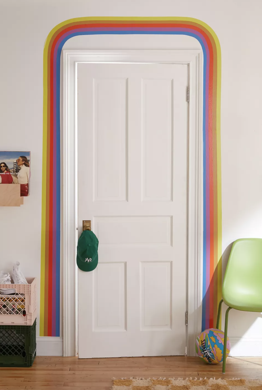 a rainbow coloured wall decal arranged around a doorway