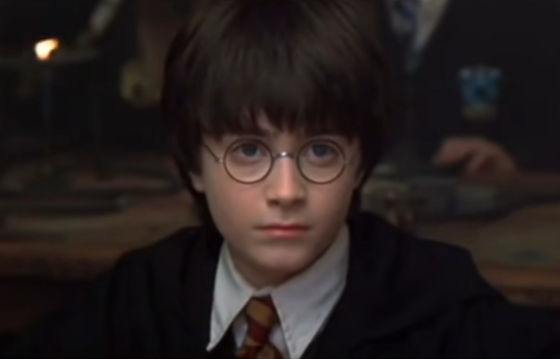 Daniel Radcliffe as Harry Potter sits and listens to a lecture during a Hogwarts class