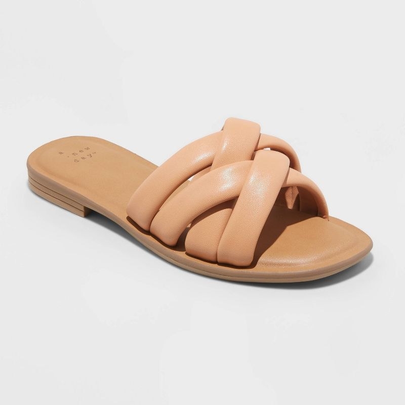 A pair of nude sandals with tan base