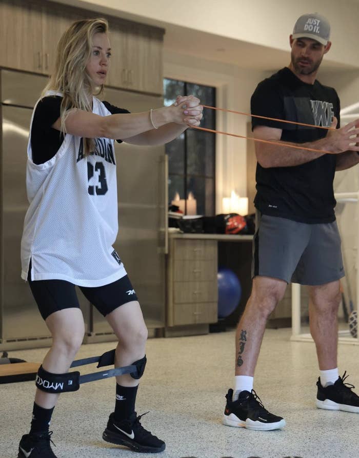 Kaley Cuoco exercising with her trainer