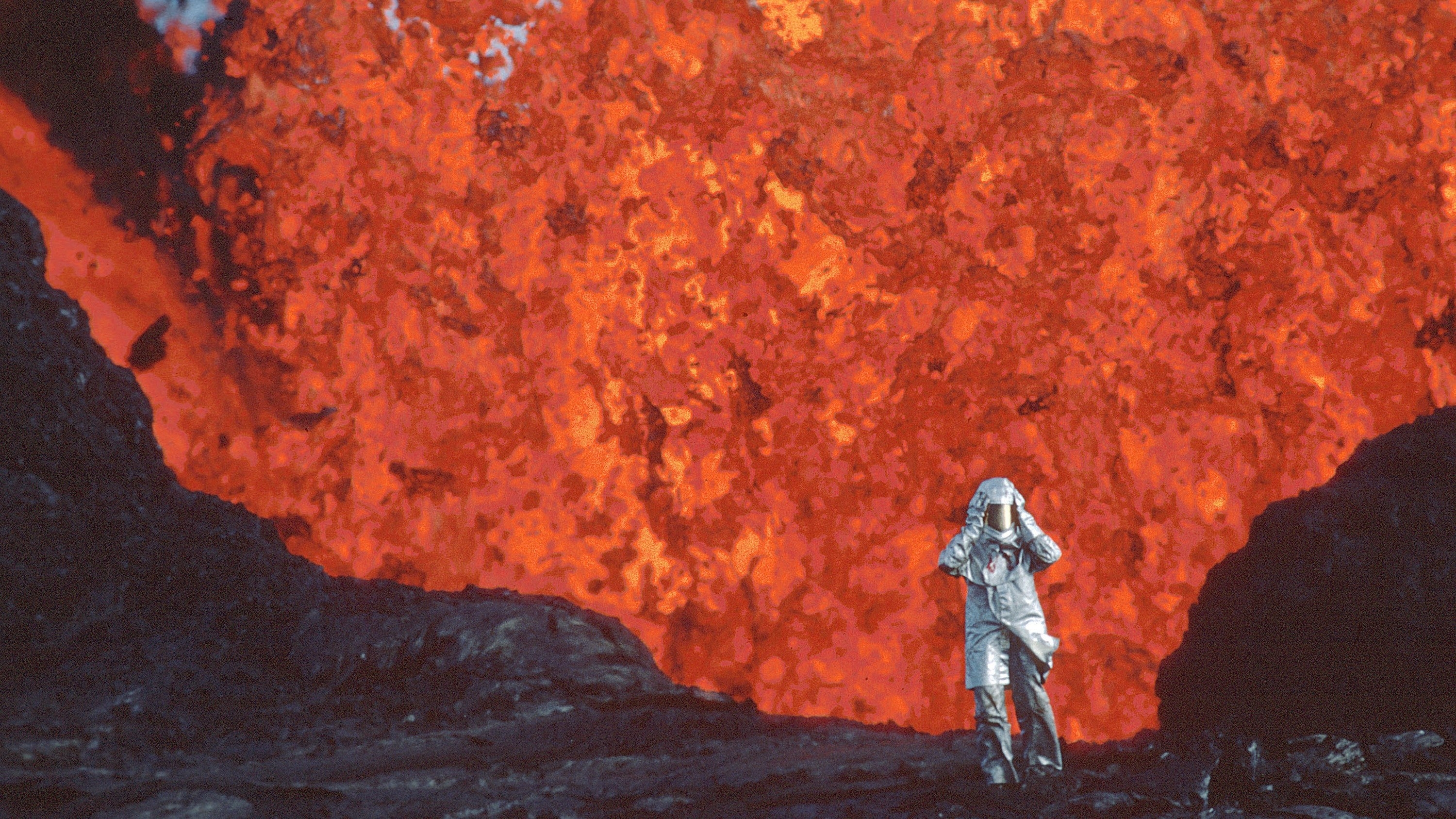 A woman wearing an aluminum suit on a volcano