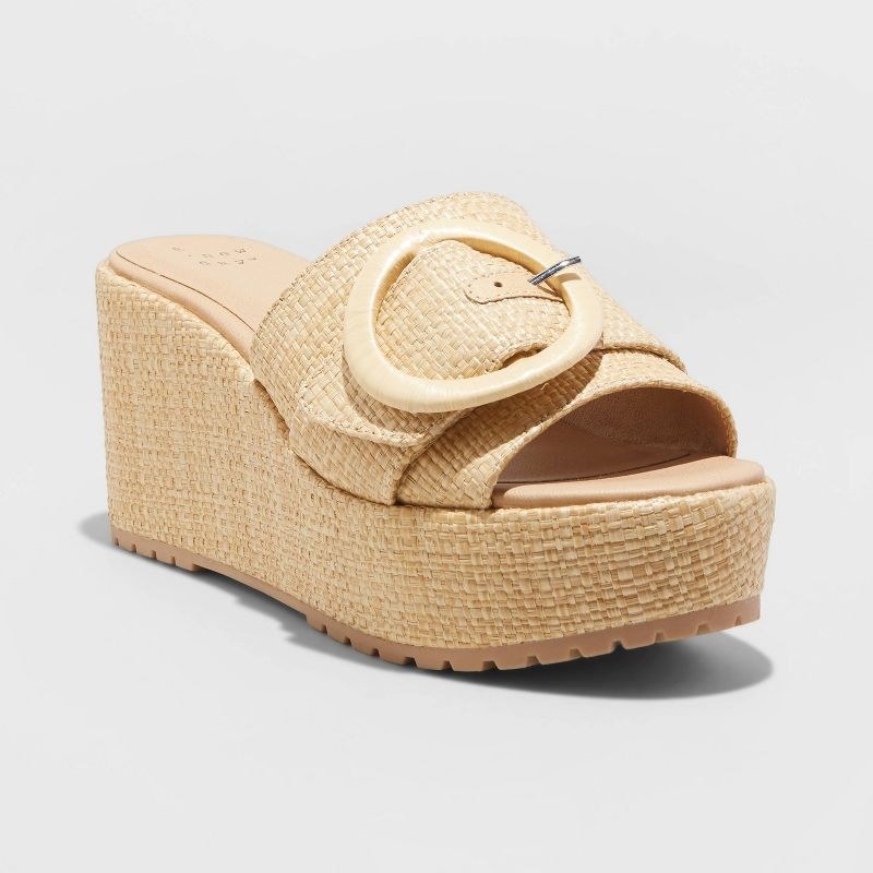 A pair of nude sandals with matching buckle
