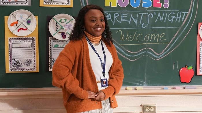 Still of a smiling teacher in front of a chalkboard from Abbott Elementary on ABC
