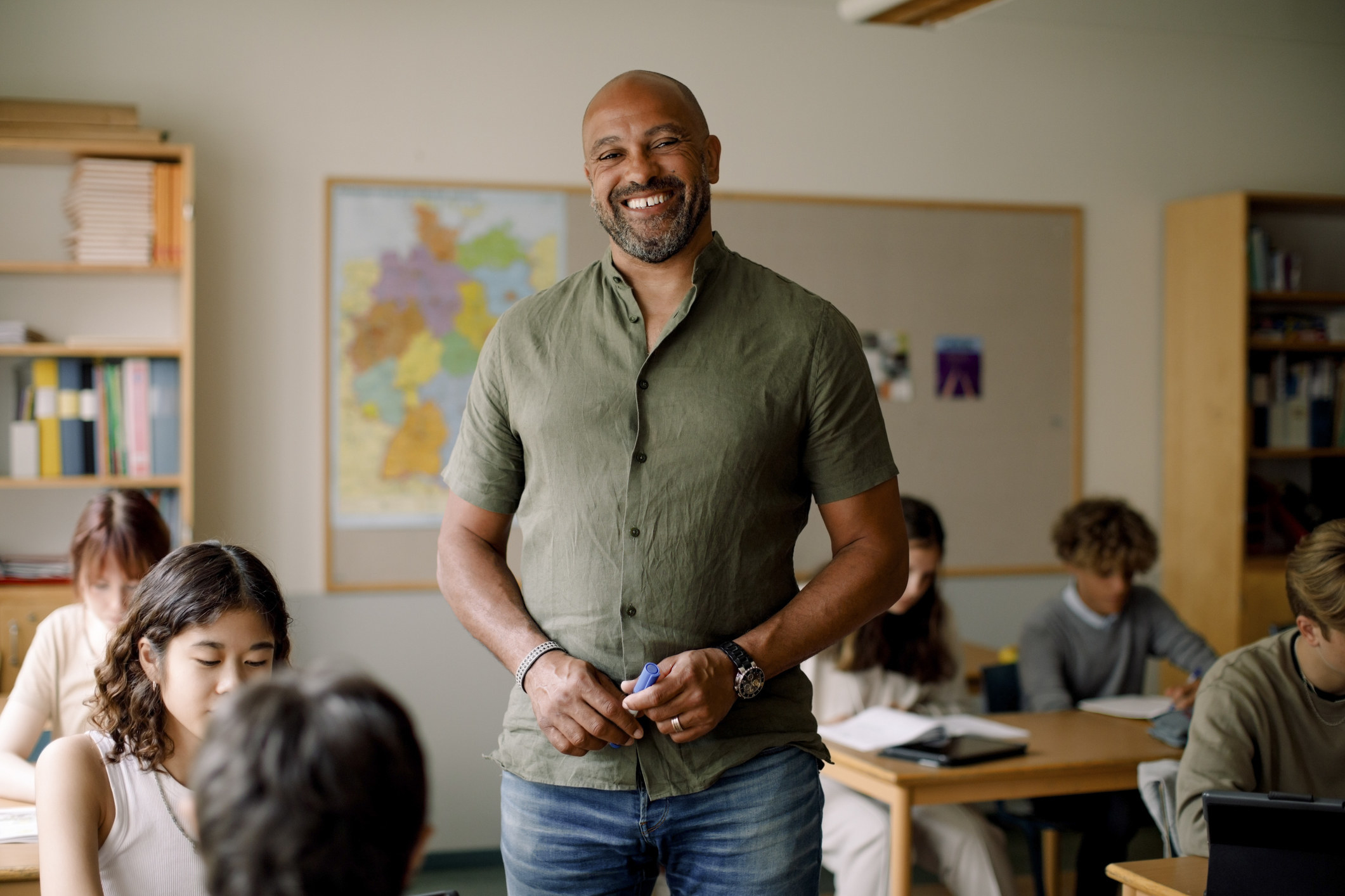 A teacher smiling in a classroom