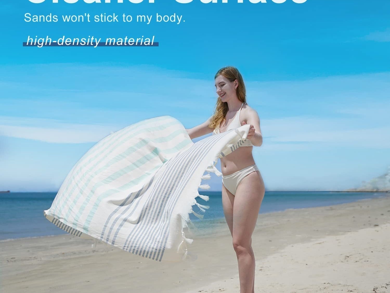 Model laying the beach towel out onto a beach