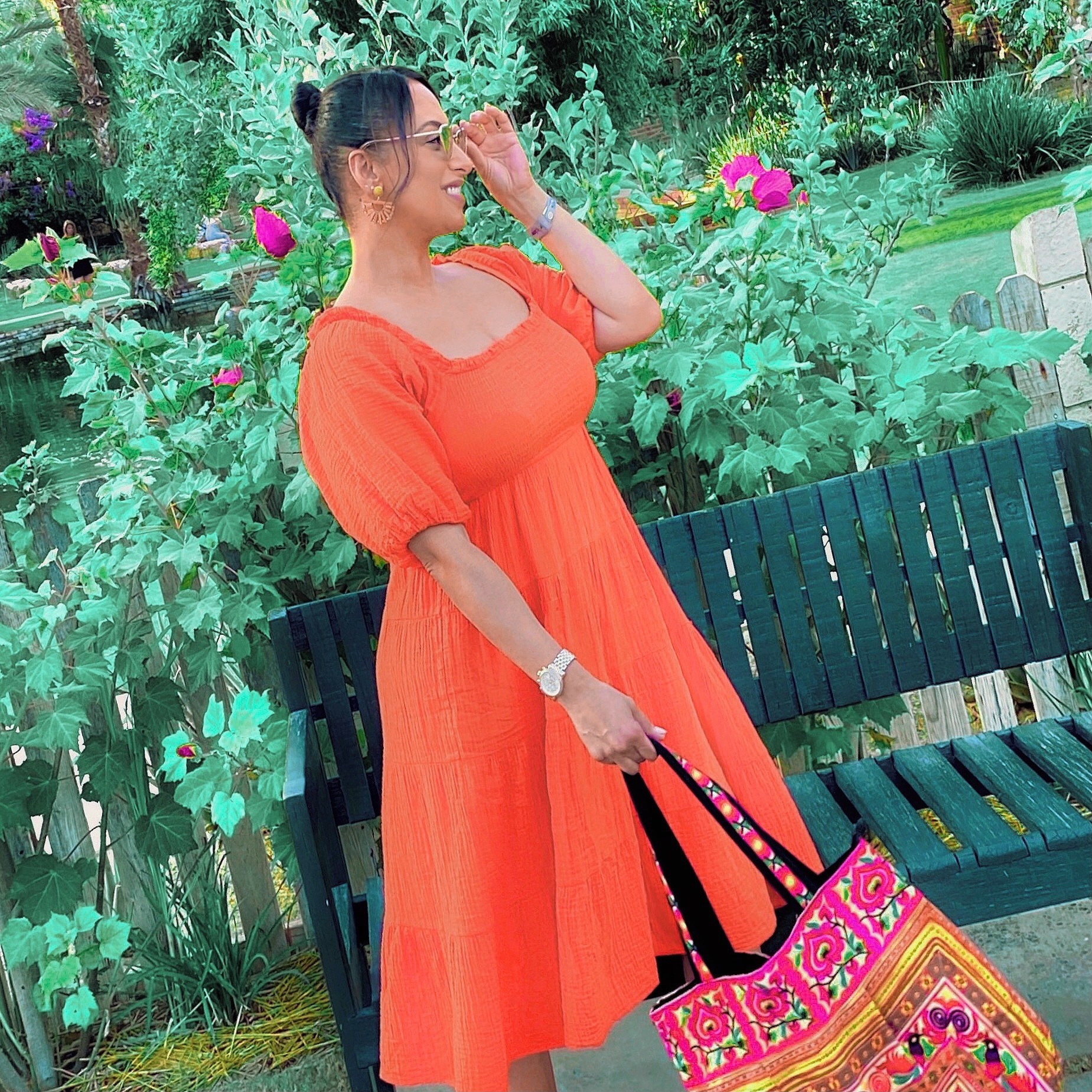 a reviewer wearing the dress in orange