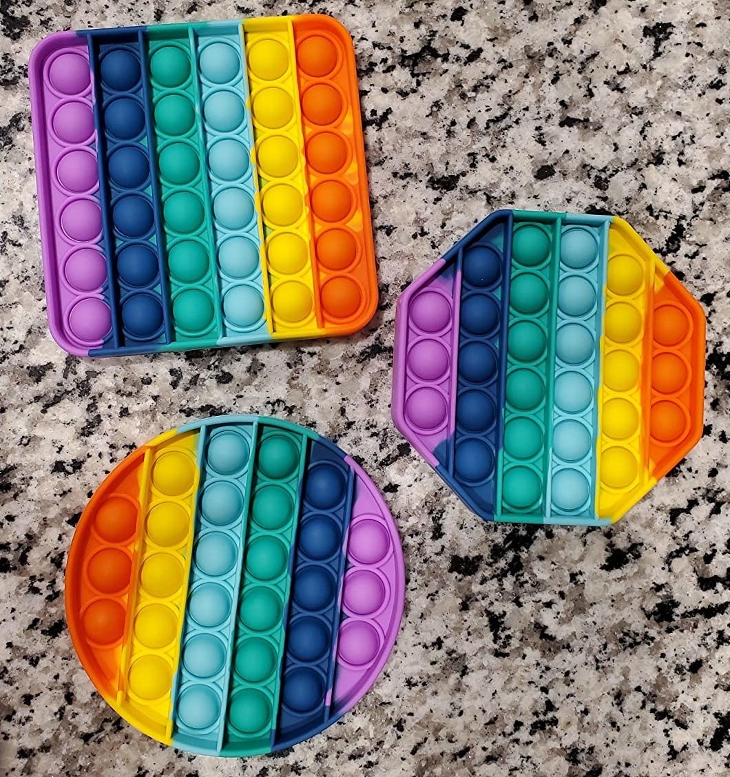 the three fidget toys in a rainbow design