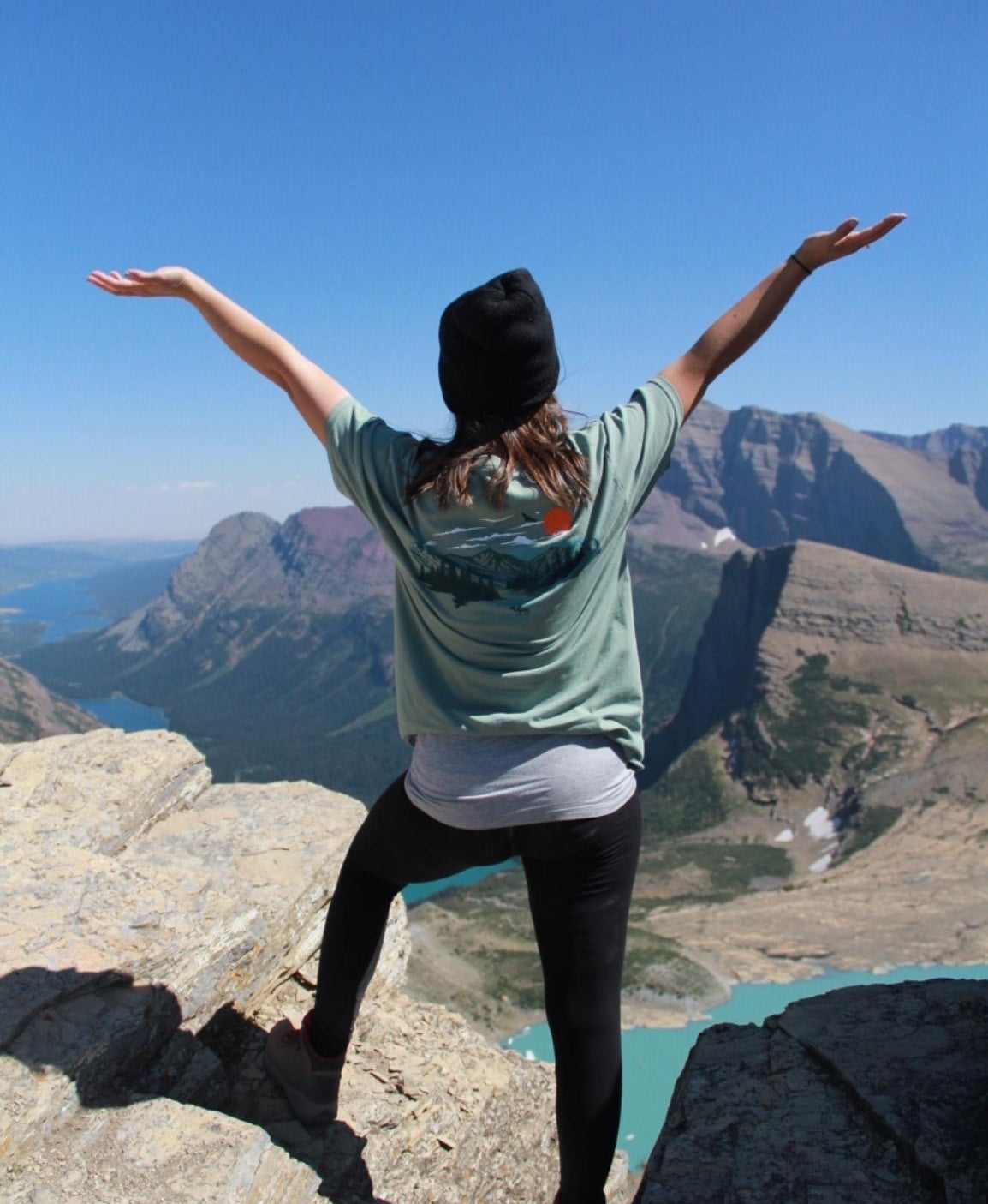 a reviewer wearing the black leggings on top of a mountain