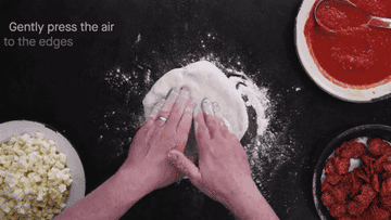 A person pressing and working with the dough