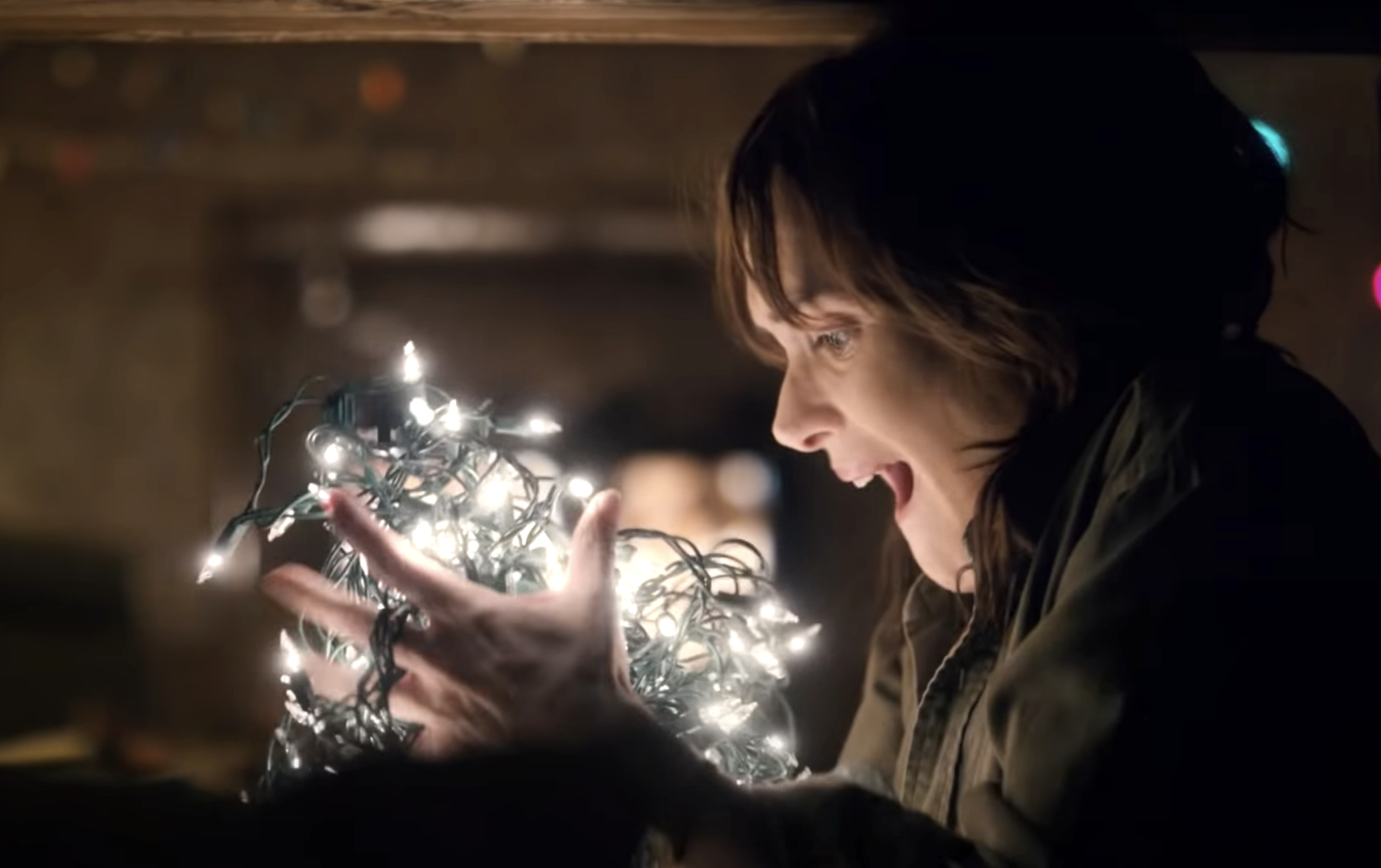Joyce holding Christmas lights