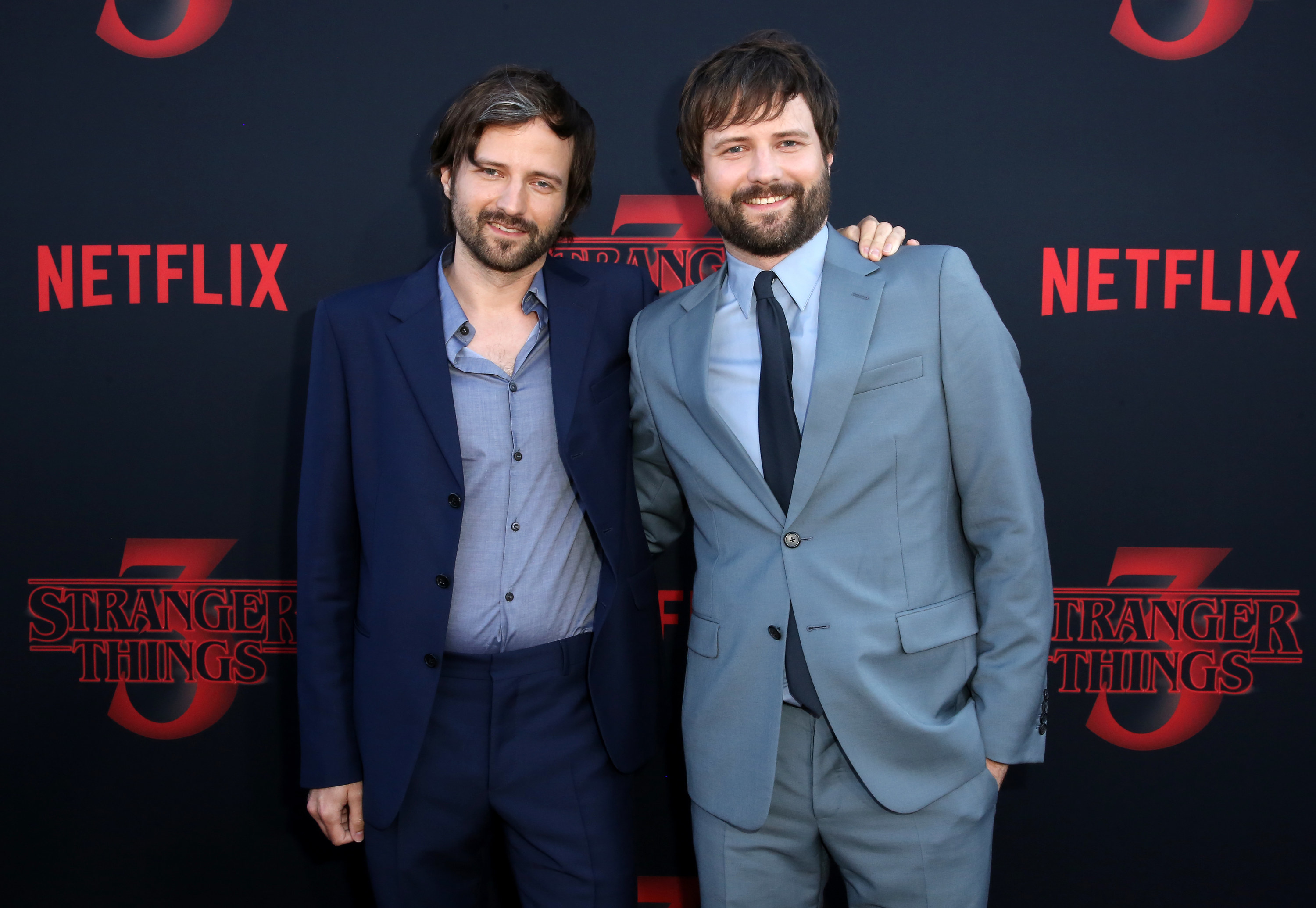 The Duffer brothers wearing suits at the Stranger Things season 3 premiere