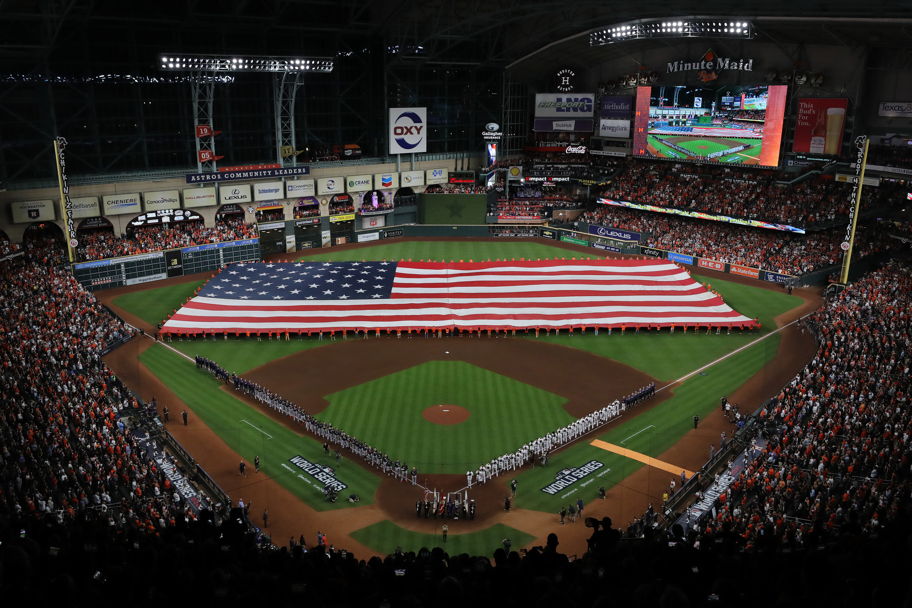 a huge flag on a baseball field