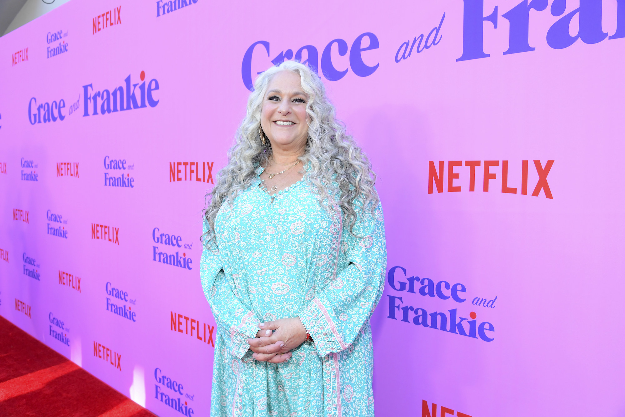 Marta standing on the red carpet for a Grace and Frankie event